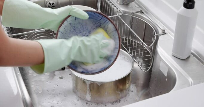 Wash dishes in the kitchen