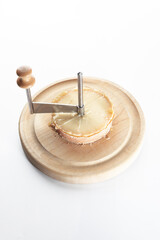 Slice the tete des Moines cheese with a girolle knife. A kind of Swiss semi-hard cheese. A special cheese knife. Copy space. Isolated object.Vertical photo.