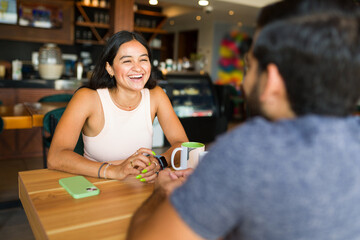 Cheerful woman talking with her boyfriend during a date