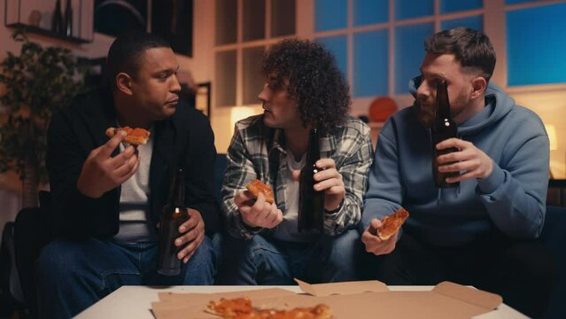 Group of diverse male friends having fun at pizza night, dorm party, friendship