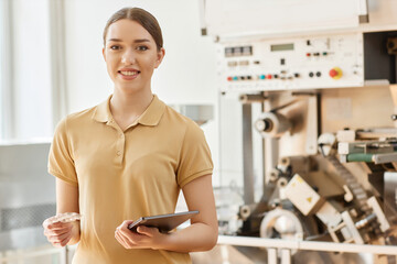 Waist up portrait of smiling young woman working at pharmaceutical factory and looking at camera, copy space