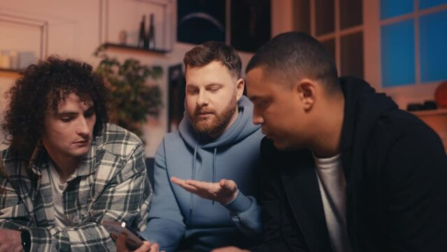 Multiethnic male friends discussing modern technology, new smartphone release