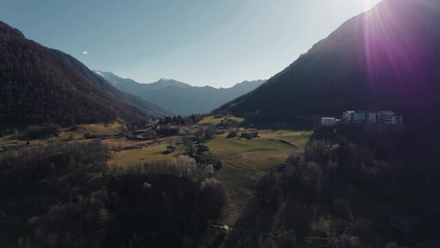 Beautiful aerial view of the Valsassina valley in the Lombardy Alps at sunset, with the green fields