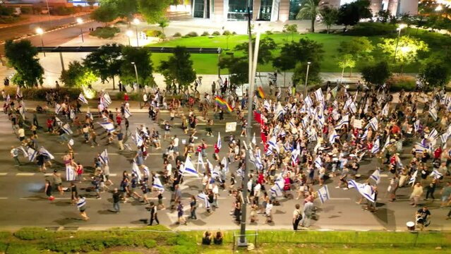 People crowd Protesting in the streets against the judicial overhaul reform, Beer Sheva, Israel, During Night, aerial side view