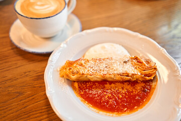 Lasagna bolognese close up. Served traditional Italian cuisine. DIsh with pasta, meat, tomato sauce, grated cheese and basil leaves in plate. Italy culinary. Restaurant food portion, main course