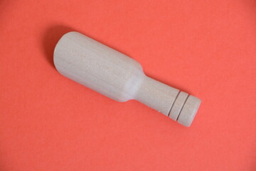 Wooden scoop isolated on a red background.