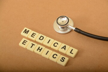 Stethoscope and alphabet letters with text MEDICAL ETHICS.