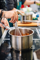 Chef cook hand cooking food  at the restaurant kitchen