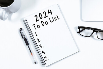 To Do List 2024 text on notepad with laptop  on white background
