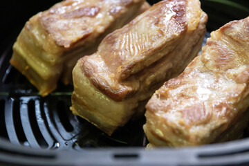 Crispy roast pork belly with air fryer. Place the pork belly in the air fryer and cook for 30 minutes. This will help to dry out the skin and create a more crispy skin. 