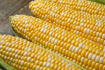 Fresh corn cobs on table, closeup
