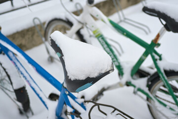 Bicycle seat covered with snow.