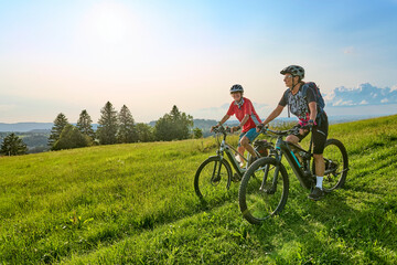 Fototapeta na wymiar two senior girlfriends having fun during a cycling tour in the Allgau Alps near Oberstaufen, Bavaria, Germany