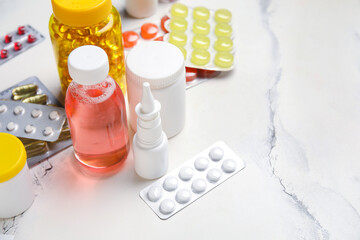 Different pills and bottles of medicines on white background
