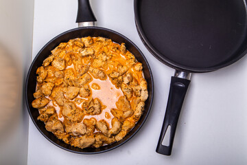 Turkey goulash in a frying pan on a white background
