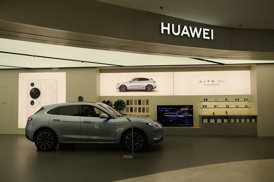 Shanghai,China-July 23th 2023: AITO electric car in HUAWEI store. HUAWEI retail store and company brand logo