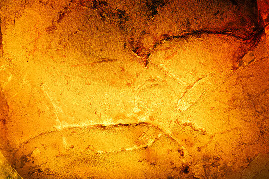 amber texture backlit. macro detail texture background. close-up raw rough unpolished semi-precious gemstone