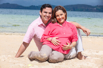 Young couple waiting for their baby at the beautiful white beach of Lake Tota located in the department of Boyaca at 3,015 meters above sea level in Colombia