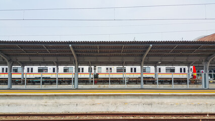 The trains stop at the station. An empty train platform.