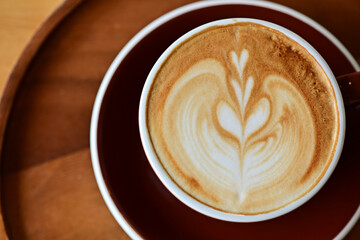 high angle view of coffee cup on wood grain table Drinking Concept: Hot Coffee, Latte, Espresso, Cappuccino