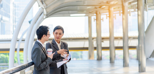 Banner Businessman Businesswoman drink coffee in town outside office modern city. Panoramic Hands holding take away coffee cup talking together happy. Copy Space Partner Business people cup of coffee