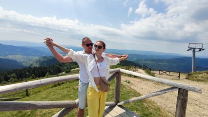 family couple on the background of mountains in summer. Carpathians Ukraine