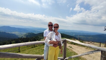Fototapeta na wymiar couple in love on a background of mountains in summer. Carpathians Ukraine
