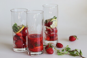 Fototapeta na wymiar Ingredients for strawberry mojito mocktail inside mojito glass for crushing.