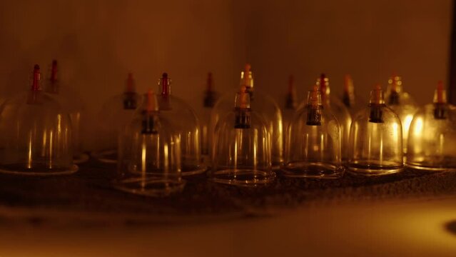 Flasks for massage on the background of candles. Spa salon, details for massage.