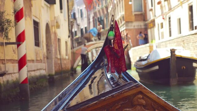 View from the front of the gondola of Venice canals and architecture of the city during ride along one of the canals in Venice, Italy.