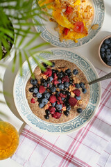 Healthy vitamin-rich balanced vegan breakfast. Raw flaxseed porridge with walnuts, berries, rosehip tea, scrambled eggs with vegetables. Useful homemade veggie lunch. Vitamins, minerals. Gluten free.