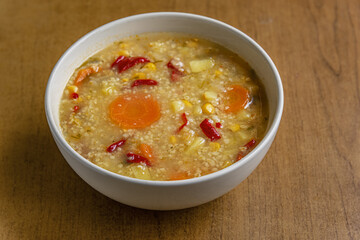home cooked vegetarian vegetable soup with bulgur and corn in a ceramic bowl
