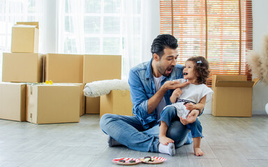 Caucasian beard handsome father and little adorable girl or daughter wearing casual jeans, sitting...