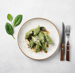 Ricotta and spinach gnocchi with butter and parmesan, italian cuisine Casentino region. top view, vegetarian dish