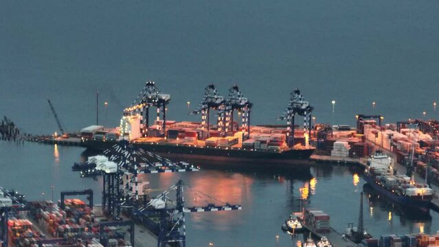 Aerial top view Container ship full load container on the green sea with beautiful wave pattern for logistics , shipping , import export or transportation.