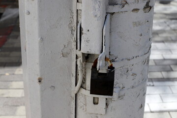 An old padlock hangs on the gate.