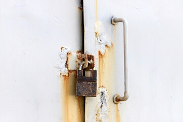 An old padlock hangs on the gate.