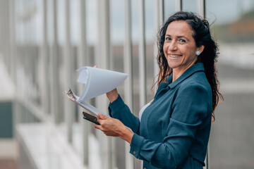 business woman on the street with documents © carballo