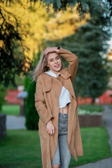 Portrait of a young beautiful fair-haired girl in the autumn park.