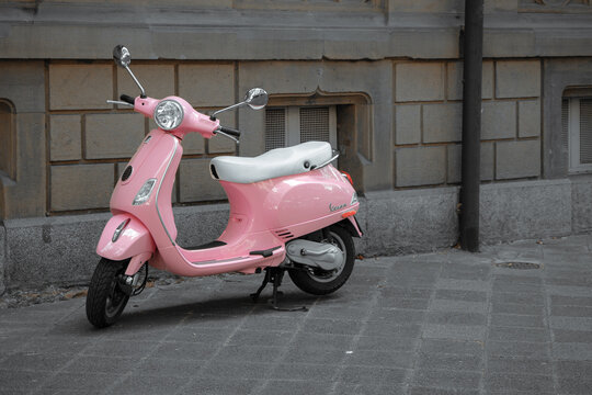 Mannheim- Germany - 22 July 2023 - profile view of pink vespa scooter parked in the street