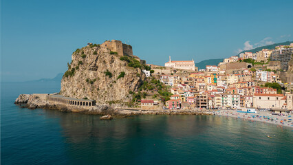 Fototapeta na wymiar Italy, July 2023: aerial view from the drone of the medieval village of Scilla and Chianalea in Calabria, with its castle, tourist port and houses directly on the sea with its restaurants on stilts