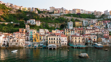 Italy, July 2023: aerial view from the drone of the medieval village of Scilla and Chianalea in Calabria, with its castle, tourist port and houses directly on the sea with its restaurants on stilts