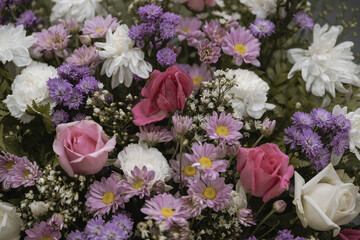Creative layout made of colorful flowers and leaves for decoration at wedding.Roses in a mixed flower bouquet on vintage style.Floral background.