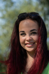 Close-up portrait of a girl in a city park in summer