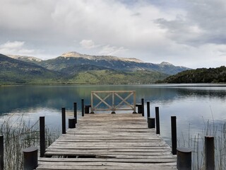 Fototapeta premium Wooden plank pier on the shore of a lake.