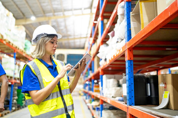 Warehouse workers checking the inventory. Products on inventory shelves storage. Worker Doing Inventory in Warehouse. Dispatcher in uniform making inventory in storehouse. supply chain concept