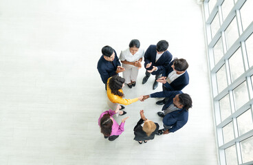 Top view of business partners shaking hands celebrating success after agreement deal in meeting...