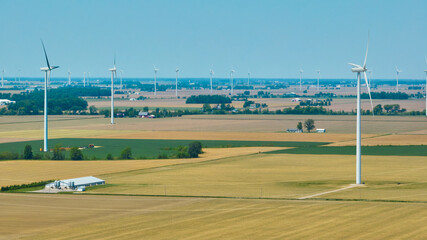 Fototapeta na wymiar Aerial wind farm in farmland rural area on summer day