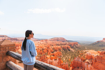 Hiker woman in Bryce Canyon hiking relaxing looking at amazing view during hike on summer travel in Bryce Canyon National Park, Utah, United States.