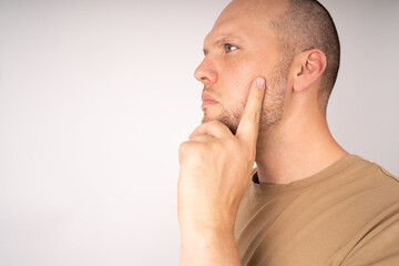 Man hold his chin with his hand and think about a solution and a good plan